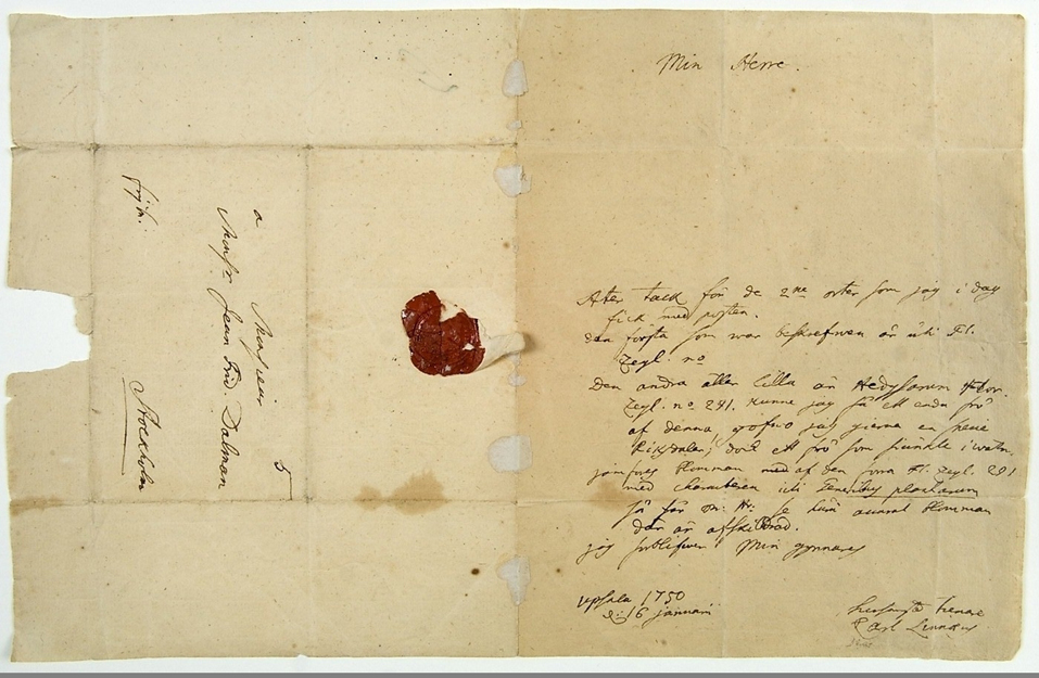 Färgfoto visar ett handskrivet gulnat brev med rött sigill.